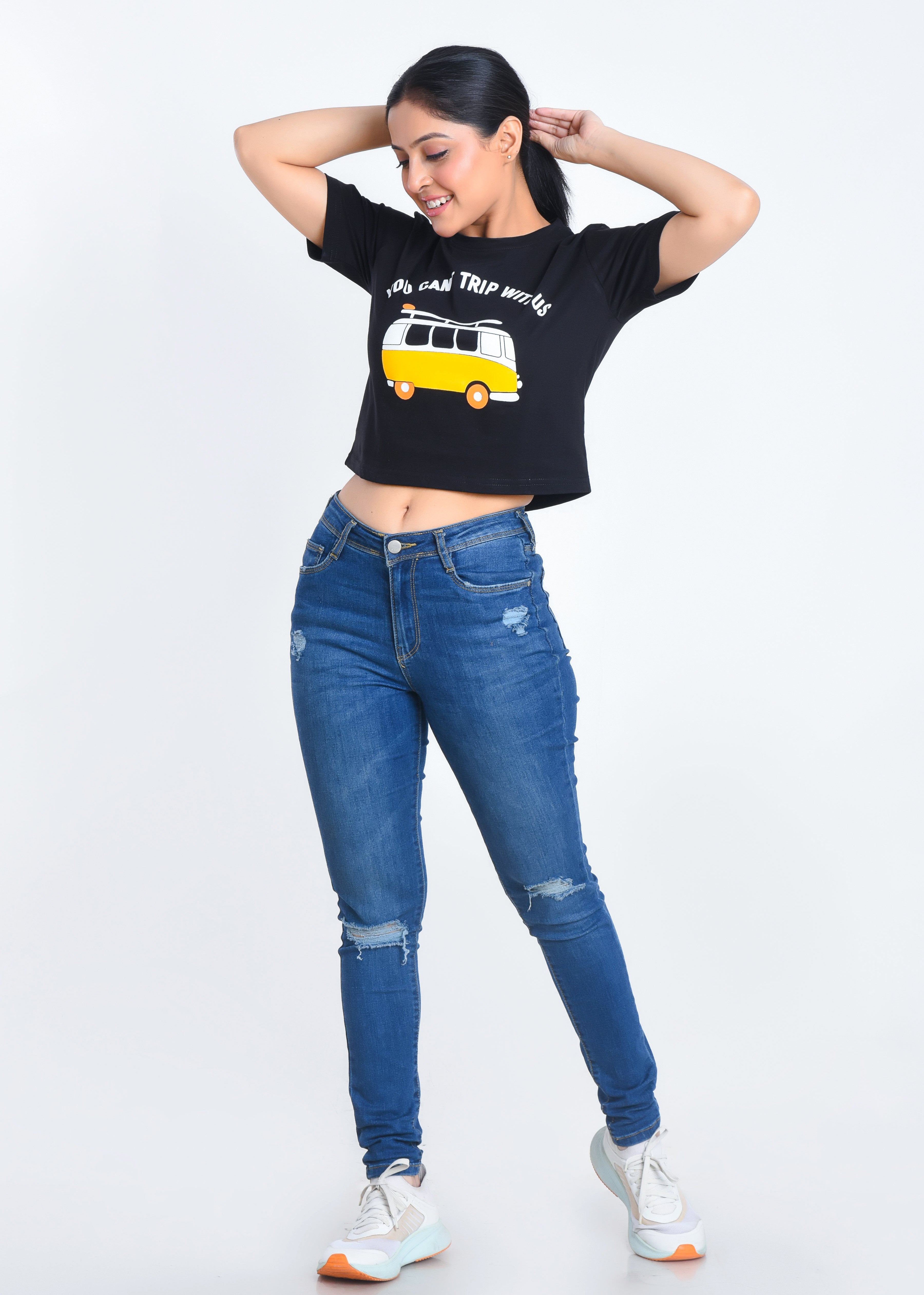 Model Posing in Black Printed Crop Top paired with jeans
